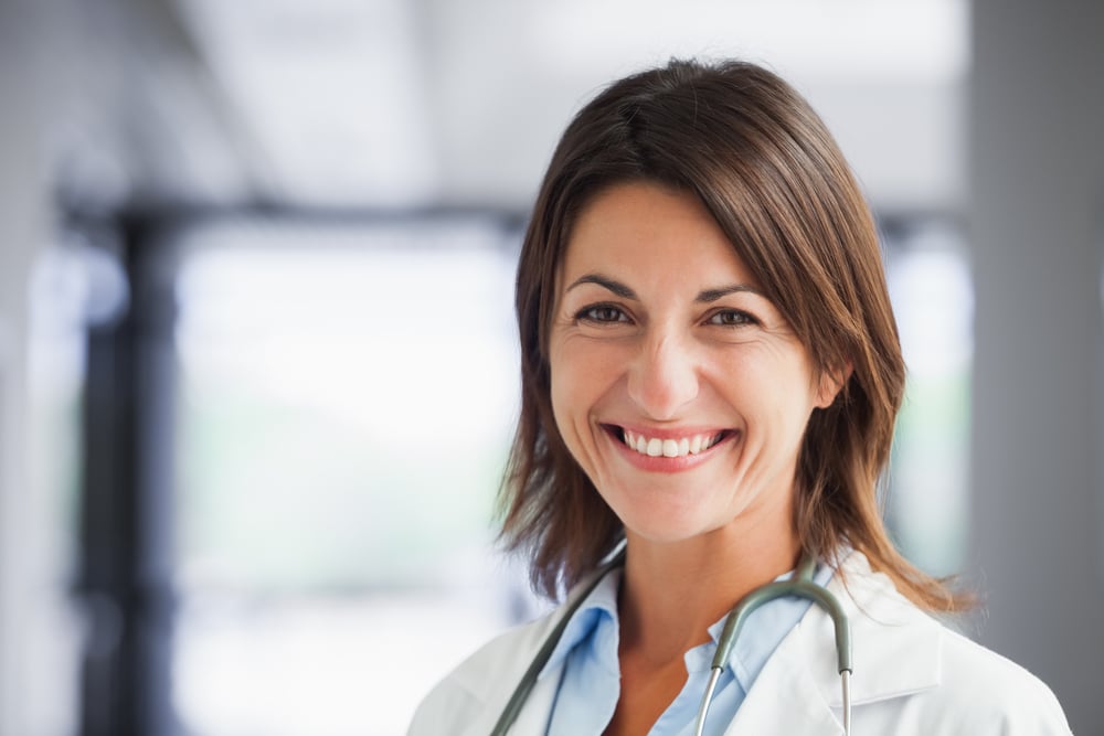 Smiling female doctor in hospital hallway